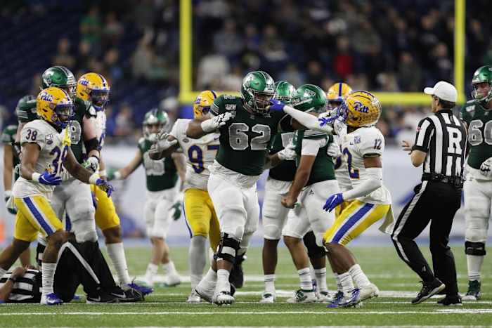 Dec 26, 2019; Pitt Panthers defensive back Paris Ford (12) grabs the facemask of Eastern Michigan Eagles offensive lineman Sidy Sow (62). Mandatory Credit: Raj Mehta-USA TODAY